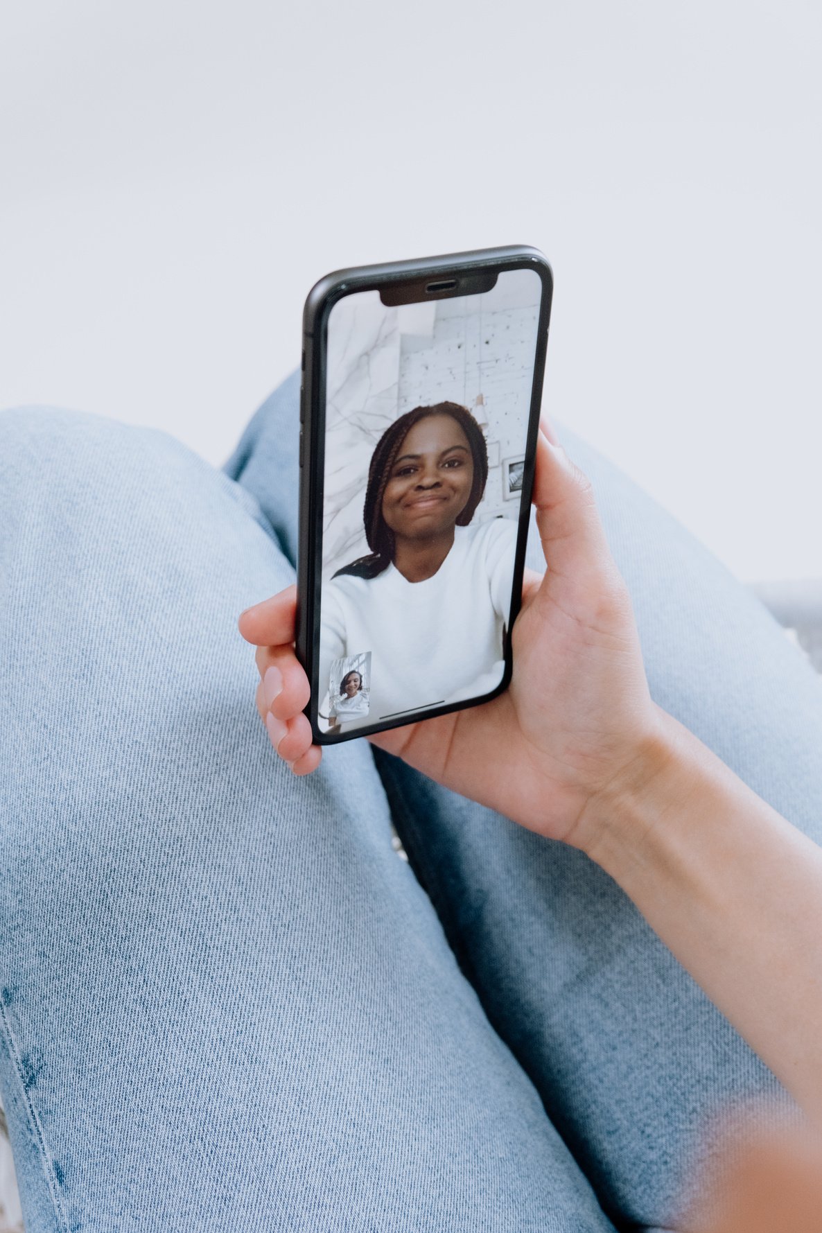 Person Holding Iphone With Black Case